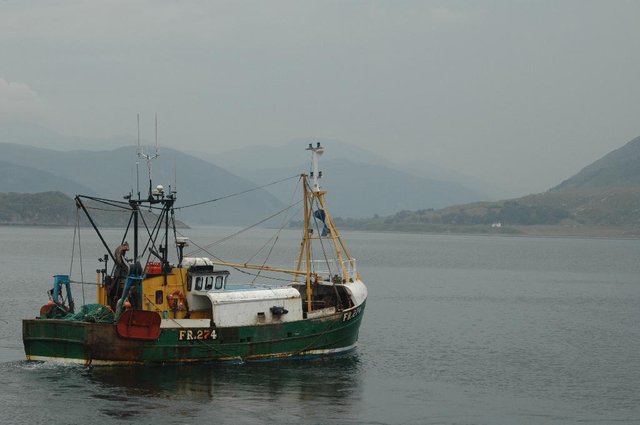 A trawler leaving the port of Ullapool, north west Scotland
